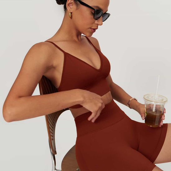 Maskert AirSoft Seamless Camisole Sports Two-Piece Set Canyon Red Sitting in a chair, holding a coffee