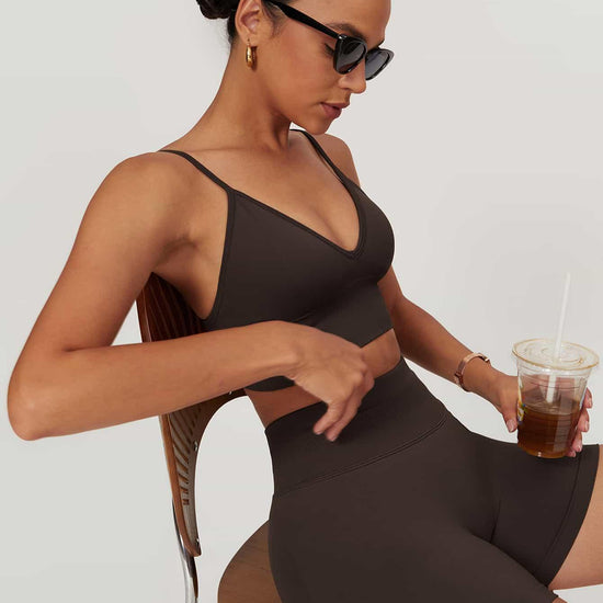 Maskert AirSoft Seamless Camisole Sports Two-Piece Set Chocolate Brown Sitting in a chair with a coffee in hand