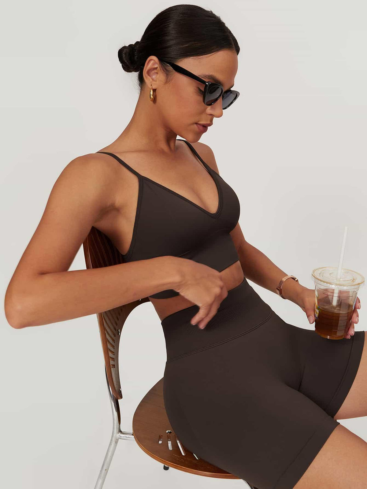 Maskert AirSoft Seamless Camisole Sports Two-Piece Set Chocolate Brown Sitting in a chair with a coffee in hand