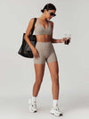 Maskert Criss-Cross Back Tank & Sculpted Leggings Set Oatmeal model carried a bag and held a coffee.