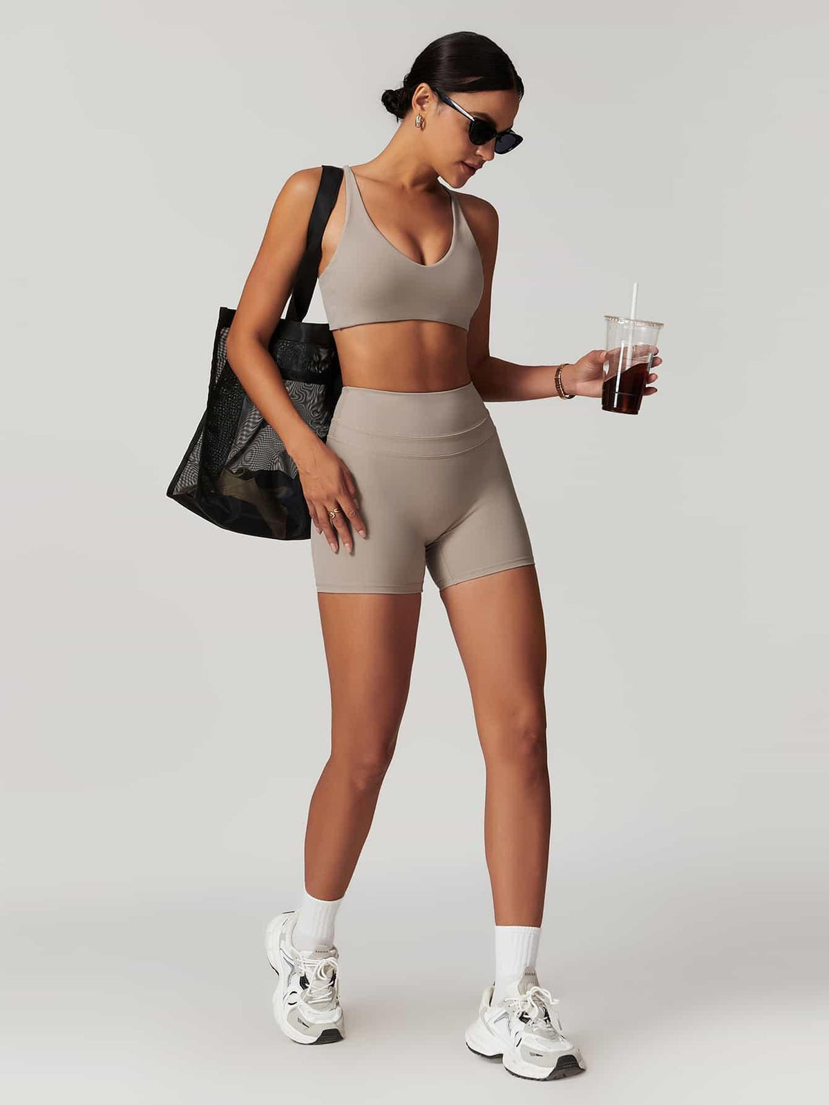 Maskert Criss-Cross Back Tank & Sculpted Leggings Set Oatmeal model carried a bag and held a coffee.