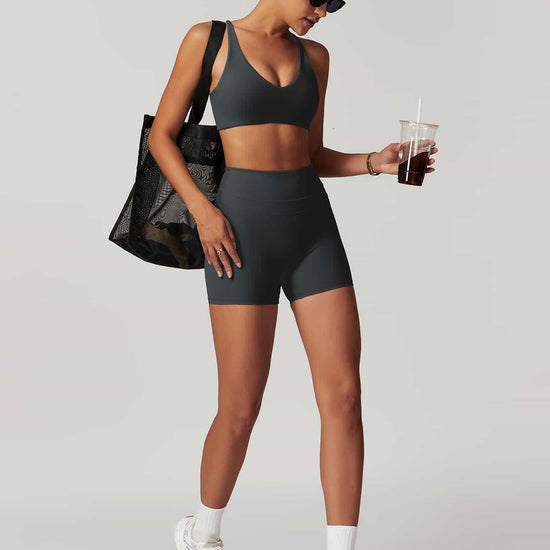 Maskert Criss-Cross Back Tank & Sculpted Leggings Set Volcanic Grey model carried a bag and held a coffee.